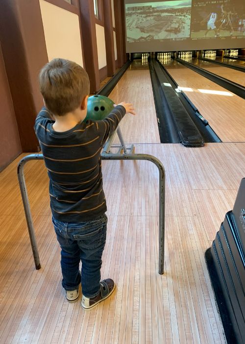 Child using a ramp to bowl at The Grand in Columbia, SC