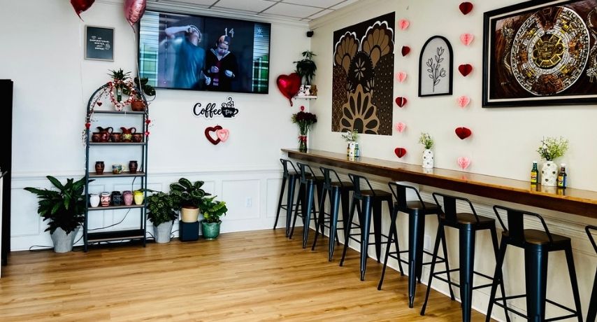 High-top chairs lining a bar counter against the wall