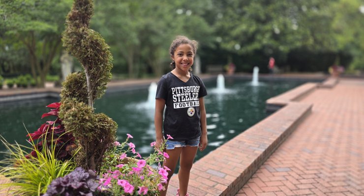 Reflecting pool with fountains and flower planters at Hopelands Gardens in Aiken, SC