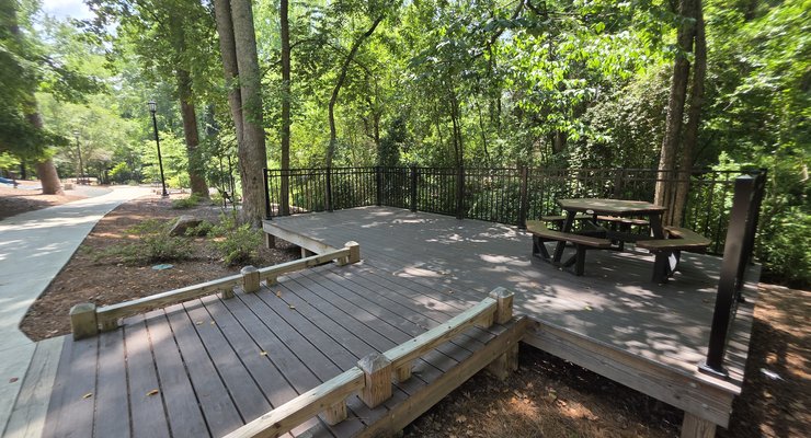 Shaded deck overlook with picnic tables along the paved trail at Virginia Hylton Park in Lexington SC
