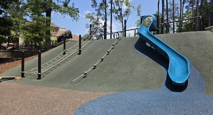 Hill slide with rope climbing net and soft padded ground at Virginia Hylton Park in Lexington SC