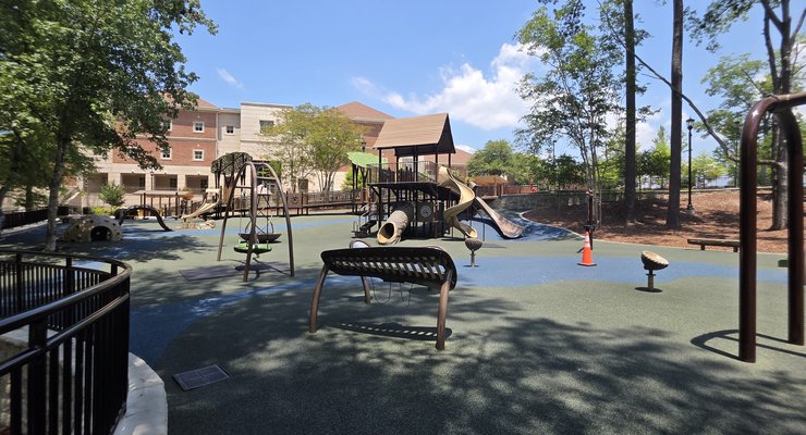 Panoramic view of the full playground area with swings slides and climbing equipment at Virginia Hylton Park in Lexington SC