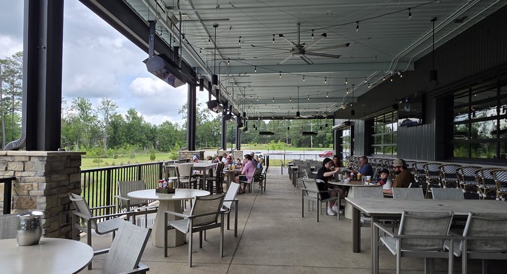 Large covered outdoor patio at 518 Smokehouse in Chapin SC overlooking a pond