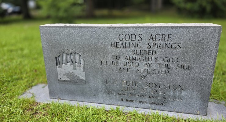 Stone marker reading God's Acre Healing Springs Deeded to Almighty God by L.P. Lute Boylston July 21 1944 in Blackville SC