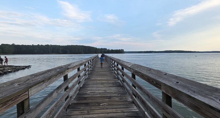 Kids walking along the wooden dock over Lake Murray at Dreher Island State Park near Columbia SC