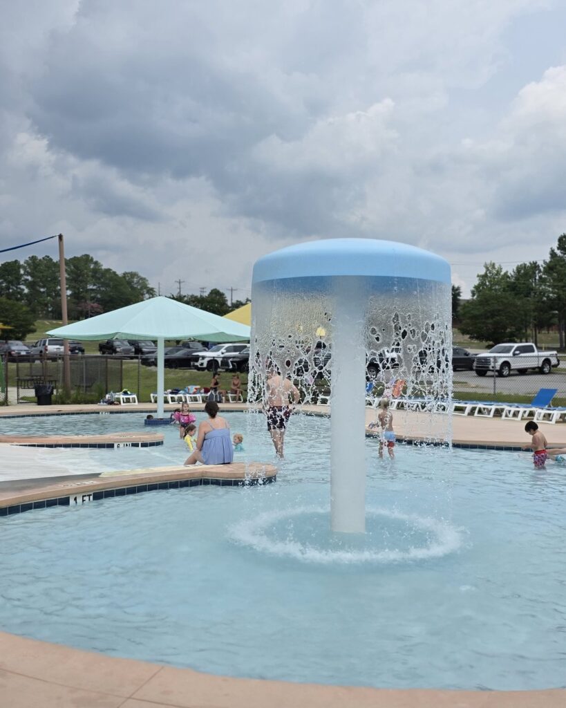 Poolside shade structures and seating area at Palmetto Falls Water Park Fort Jackson SC