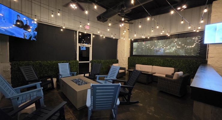 Chapin Ale House enclosed patio room with fire pit tables