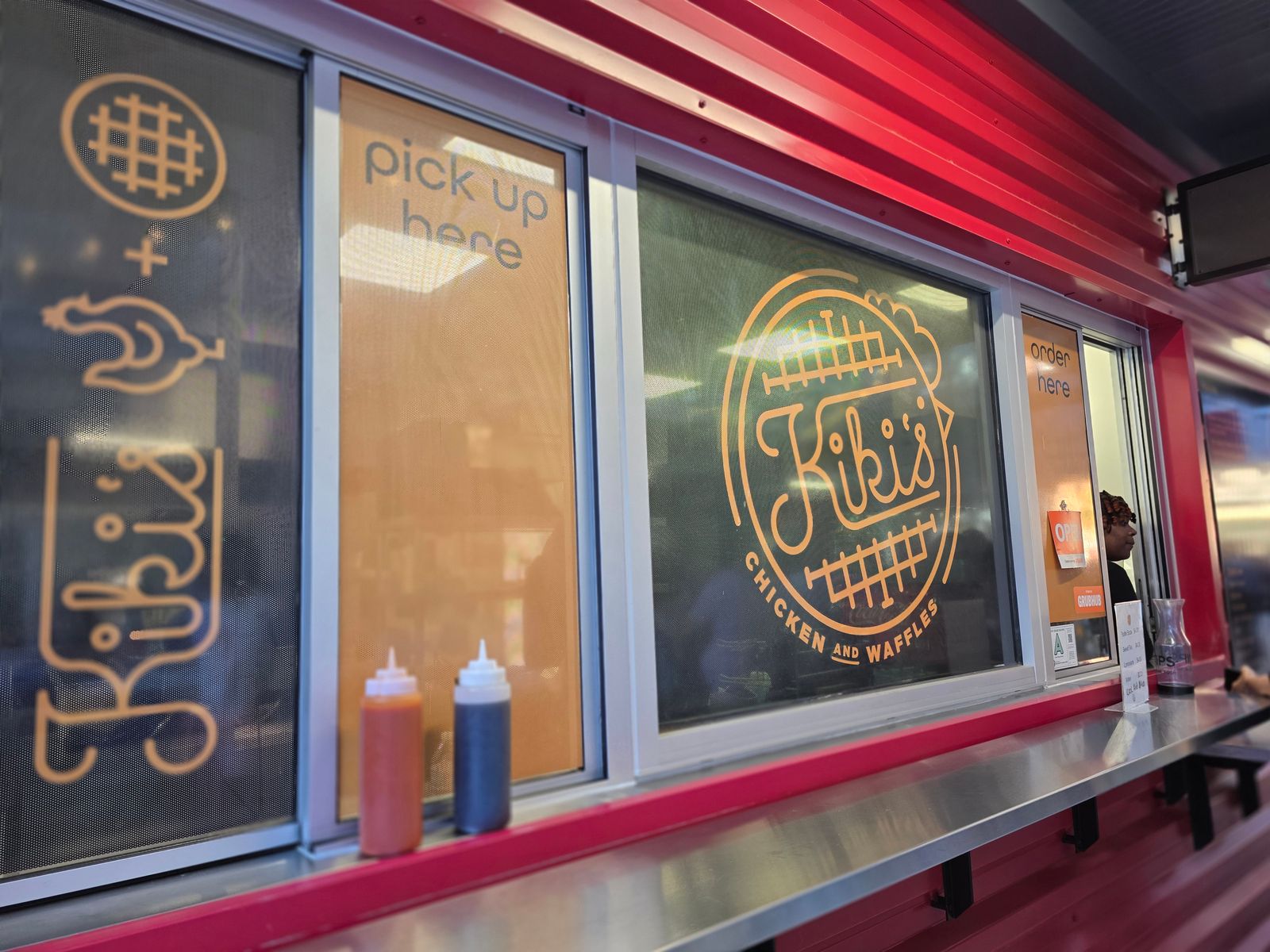 The order window at Kiki's Chicken and Waffles inside Gather COLA
