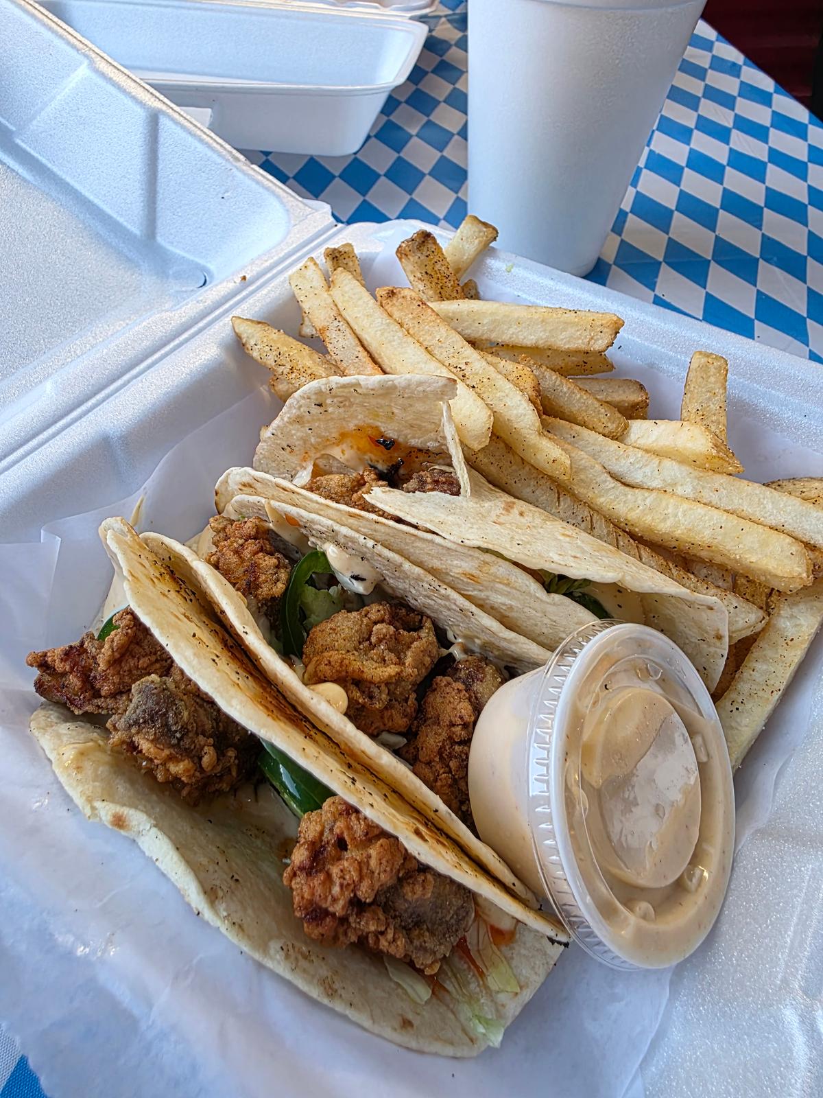 Oyster handhelds and seasoned fries from Big Easy Seafood at Gather COLA