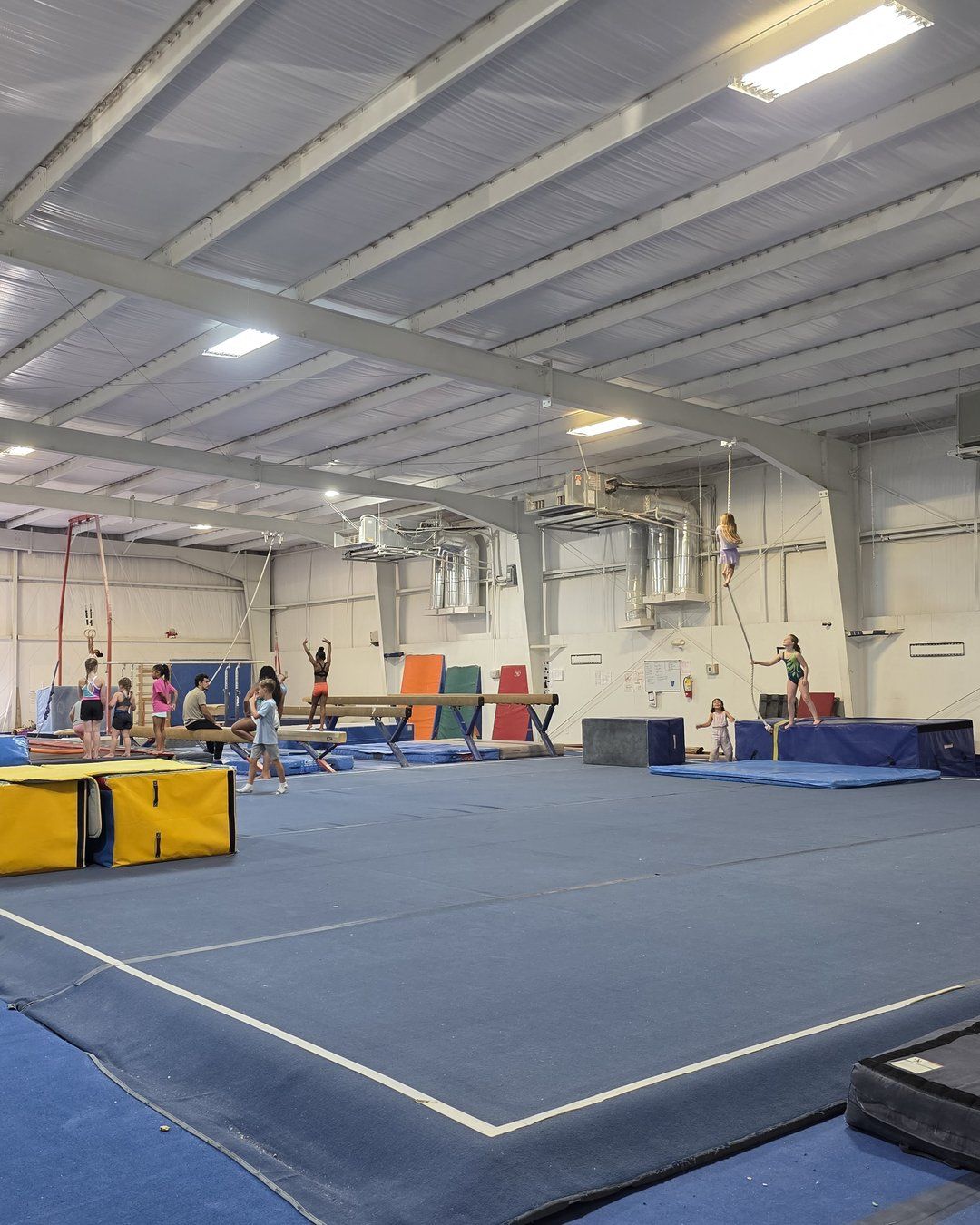 Open gym floor with beams and tumbling mats at Lake Murray Gymnastics in Irmo, SC
