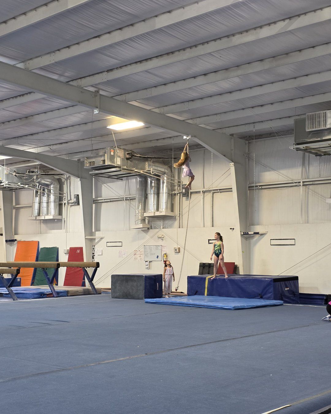 Kids practicing on beams and mats in the 10,000 square foot Lake Murray Gymnastics gym