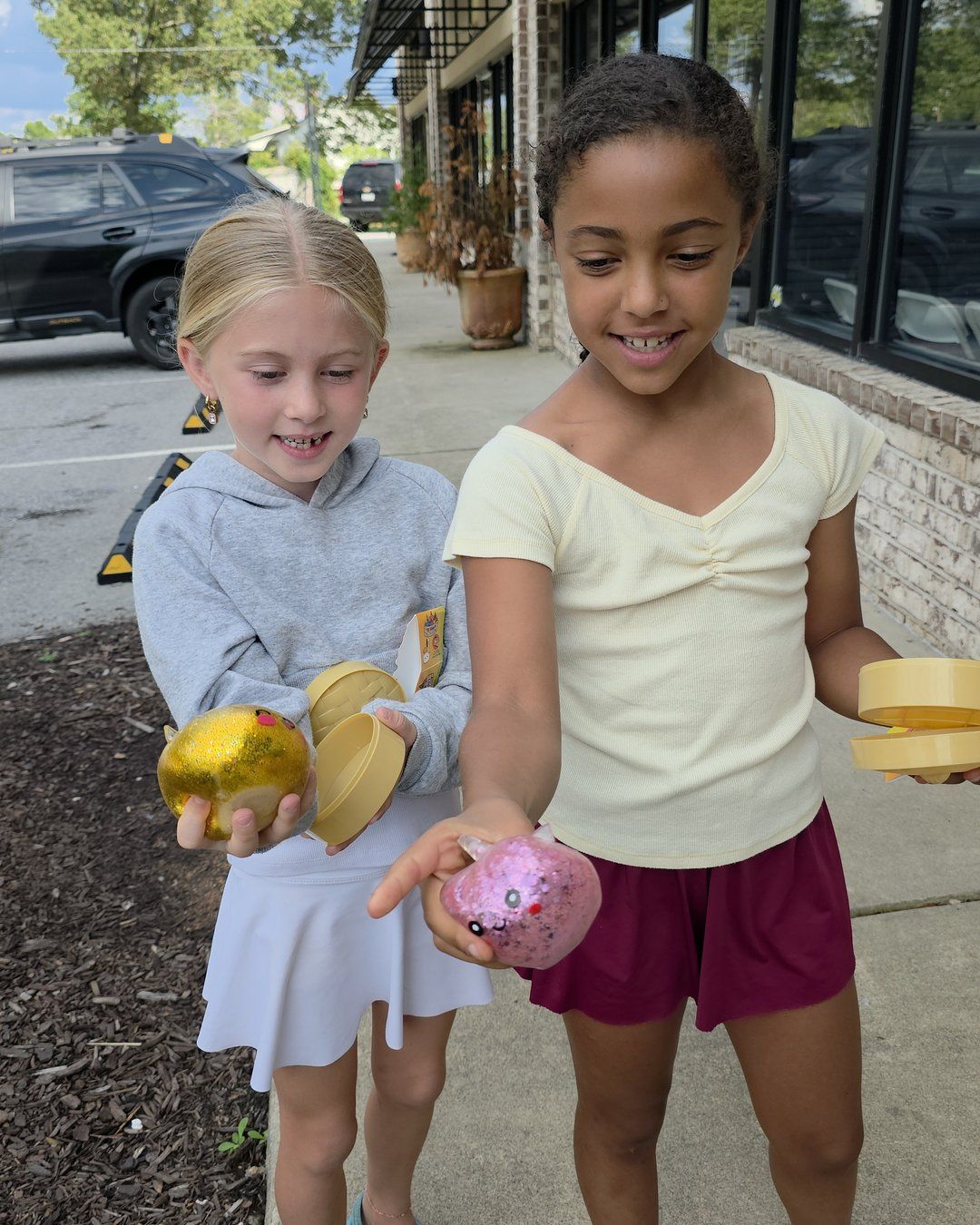 Two girls holding the squishy toys they picked outside Linga Binga in Chapin, SC