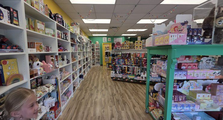 Aisle of shelves stocked with toys and squishies inside Linga Binga in Chapin, SC